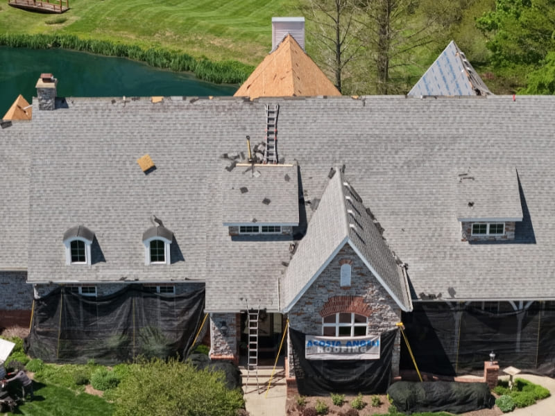 Old damaged asphalt shingle roof with curling shingles