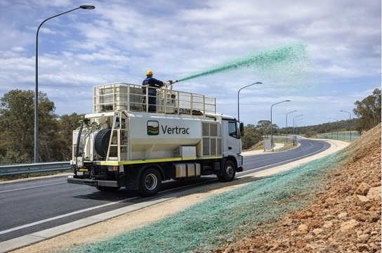 Vertrac application truck treating exposed ground beside a road