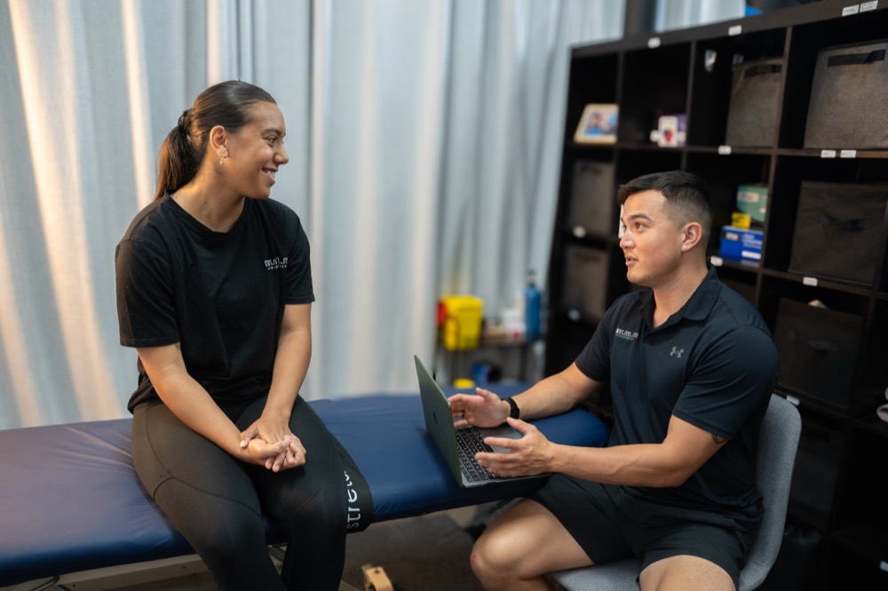 Physiotherapist explaining the assessment and discharge plan to a client