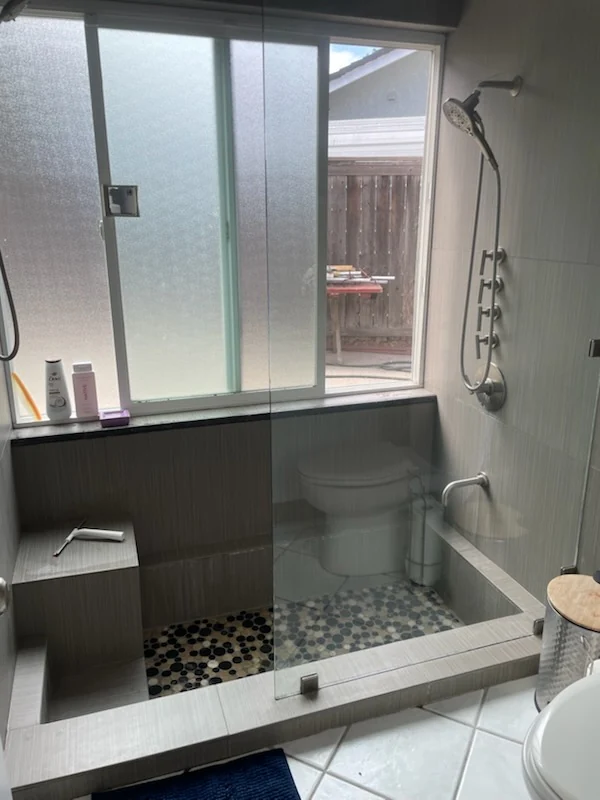 CH Cleaning Services — Tiled walk-in shower with glass partition