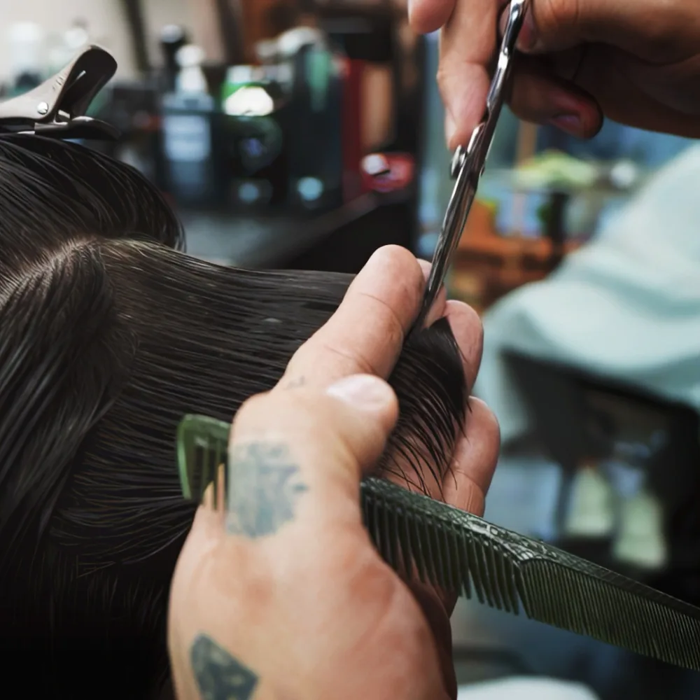 Studio AZ barber using shears and comb for a scissor-over-comb cut in Minneapolis