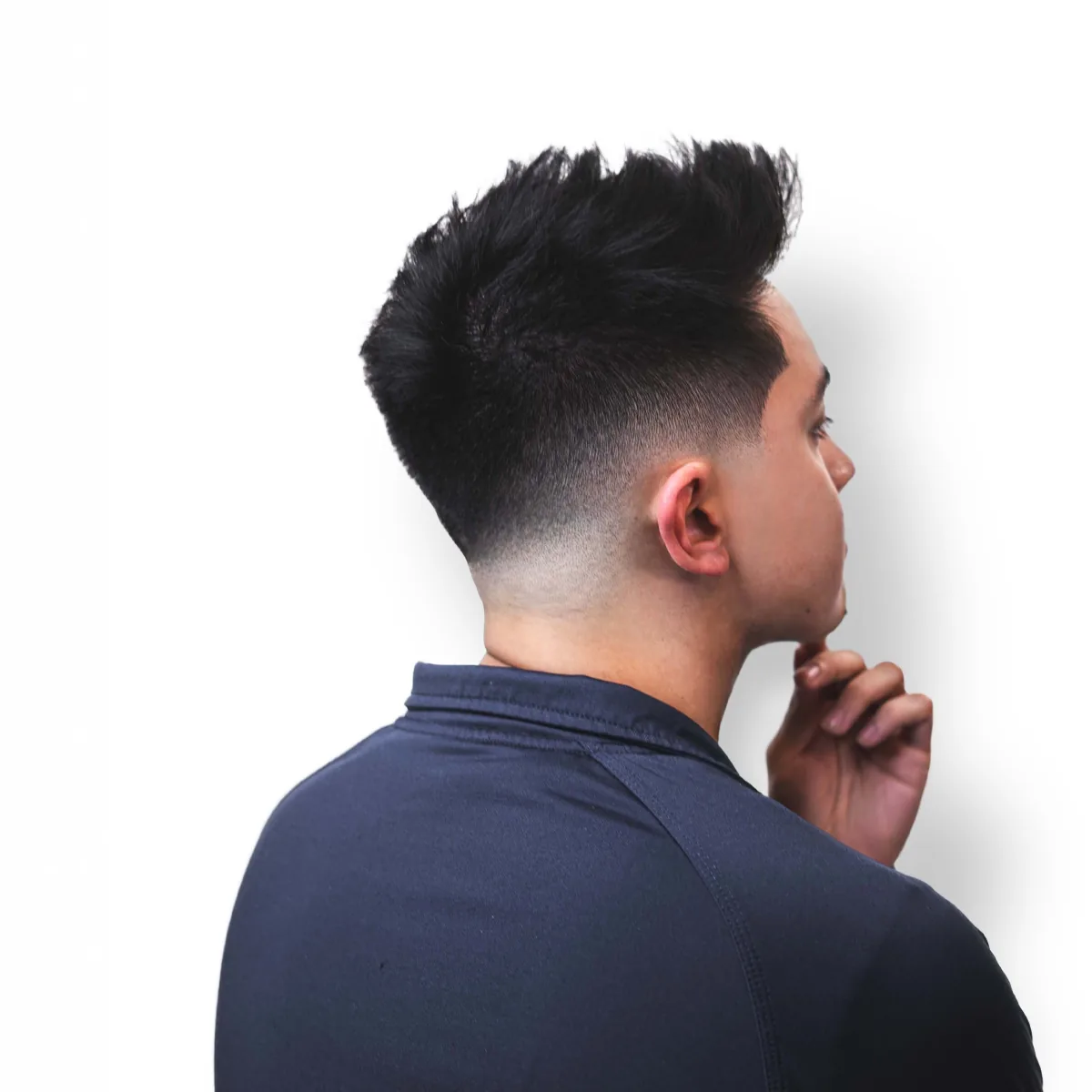 Mid fade with textured spiked top — clean transition from taper to skin, cut at Studio AZ Barbershop in North Loop Minneapolis