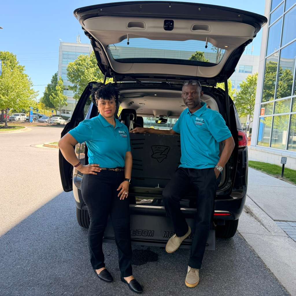 Meshach and Rita Aneke, the Registered Nurse founders of Merit Care Enterprises, standing at the rear of their wheelchair-accessible van in the Baltimore area