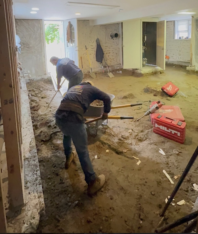 Grading and drainage correction re-sloping soil away from a residential foundation
