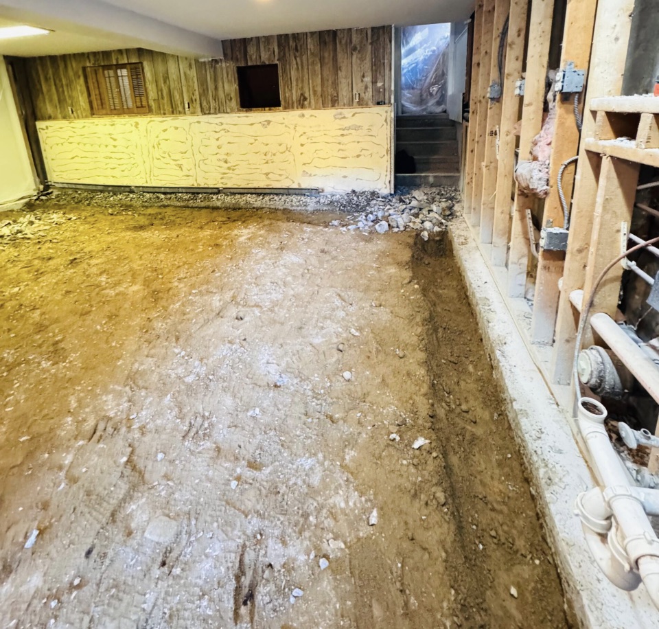 Foundation crack repair with injection ports along a leaking vertical wall crack