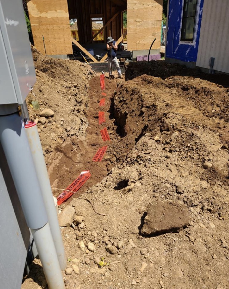 Interior perimeter drain channel and sump basin installed inside a residential basement