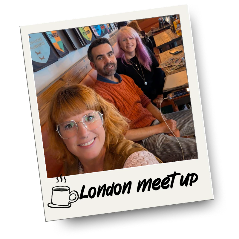 Three people sitting at a table in a cafe or restaurant, smiling for a selfie. The photo has a polaroid style with the text "London meet up" and a coffee mug icon at the bottom.