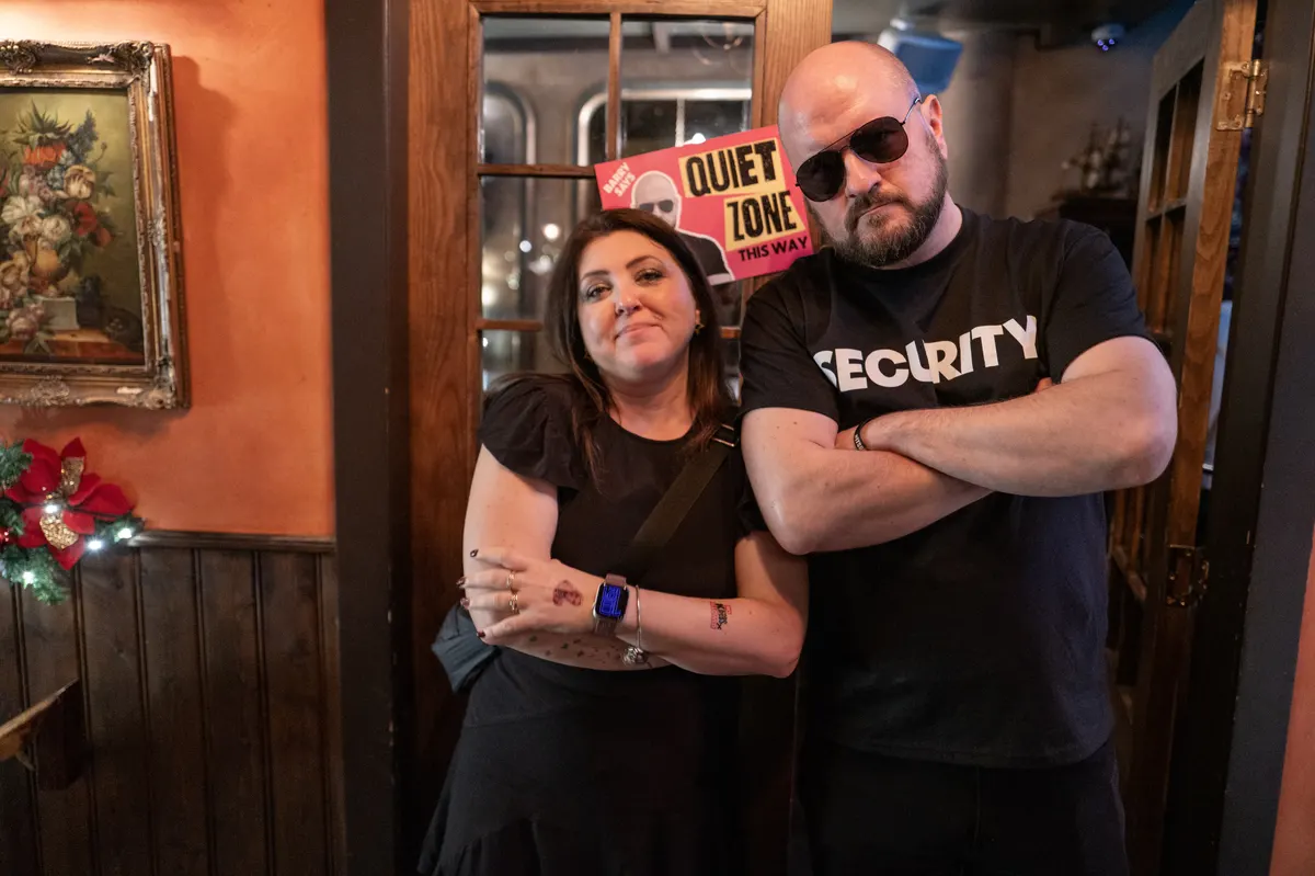 Backdoor Barry in his security T-shirt, arms folded, next to Lea Turner