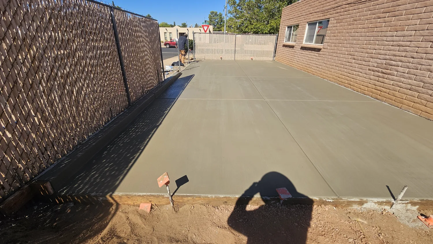 Finished concrete driveway along a block wall