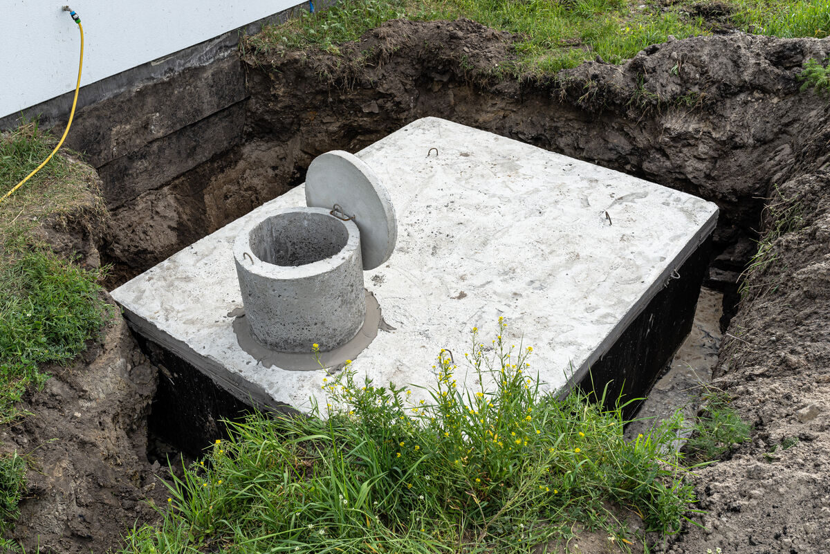 Concrete septic tank installation in residential yard