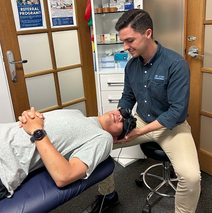 Physiotherapist using vestibular goggles