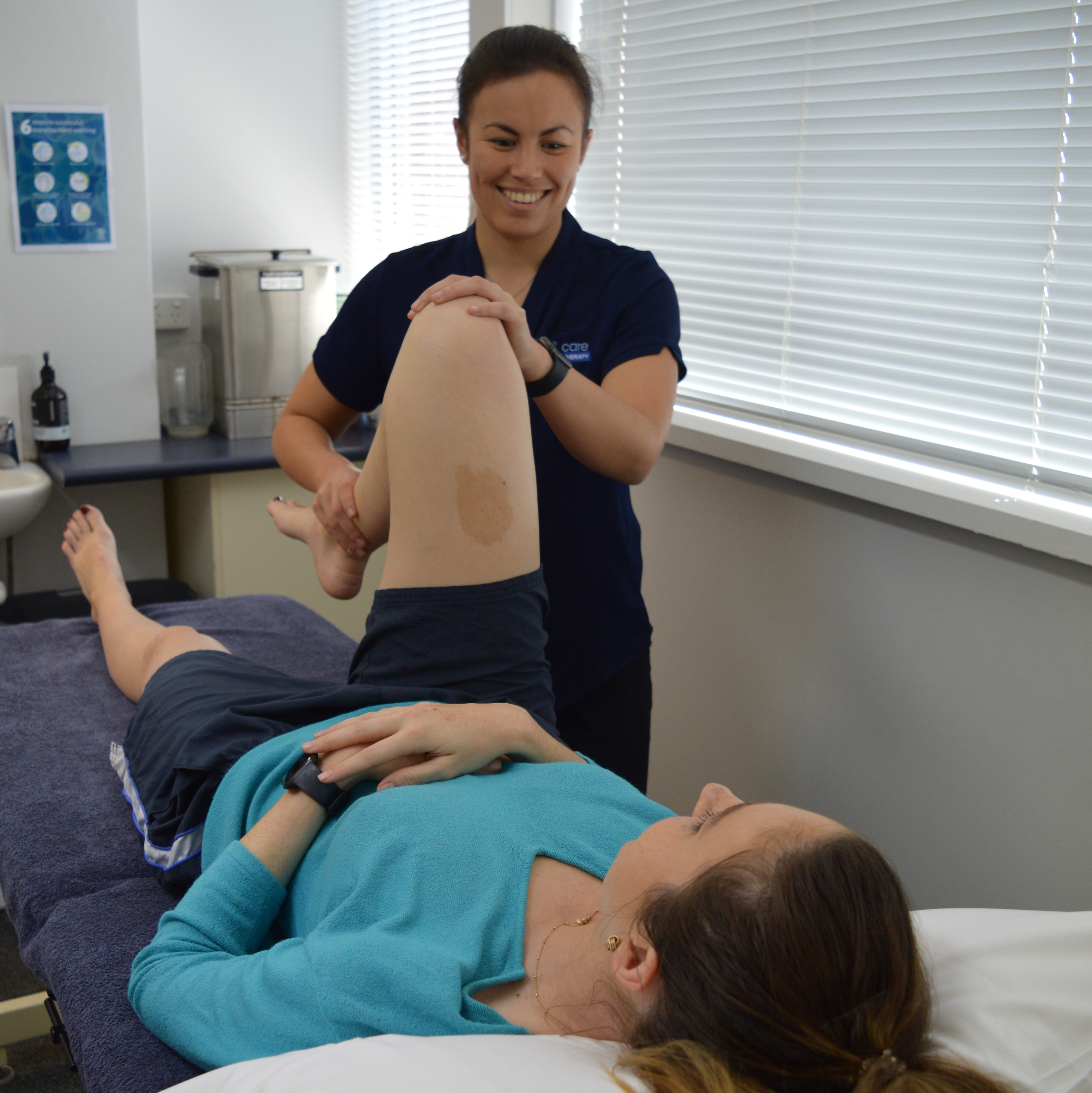 Physiotherapist treating client with knee pain