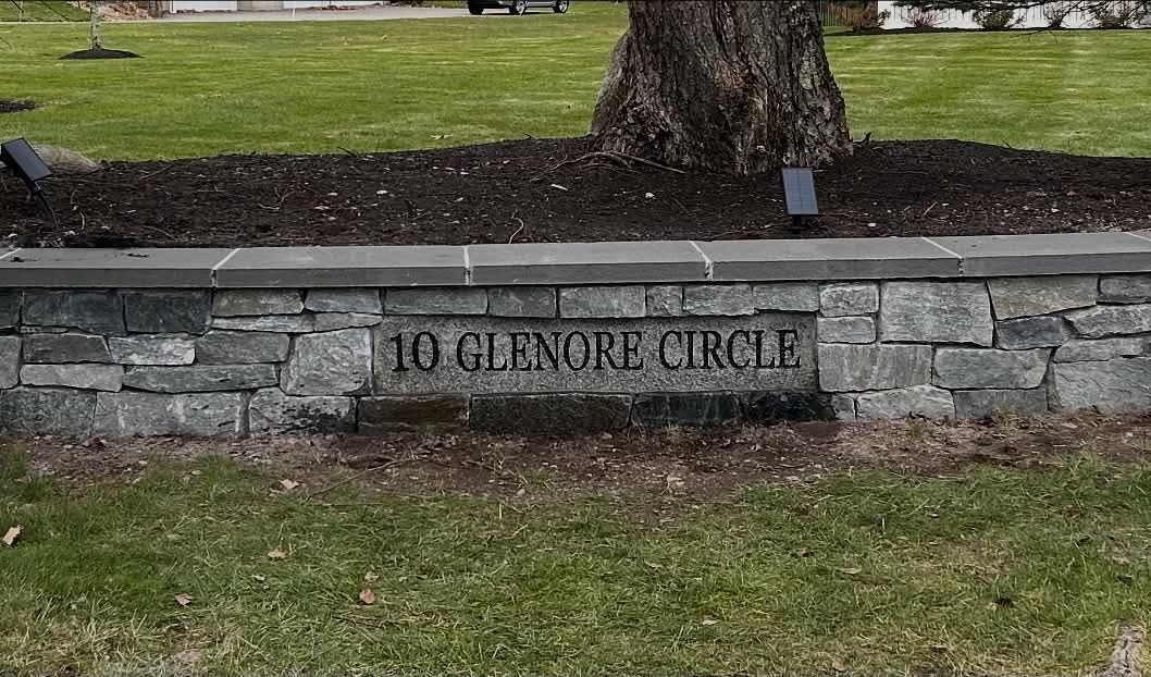 10 Glenore Circle engraved stone set into a stone wall