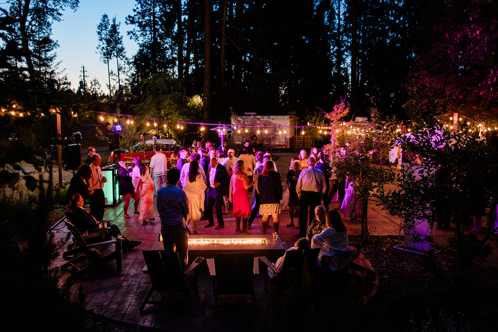 Packed dance floor at a Sacramento wedding reception with uplighting and DJ booth Packed dance floor at a Sacramento wedding reception with uplighting and DJ booth