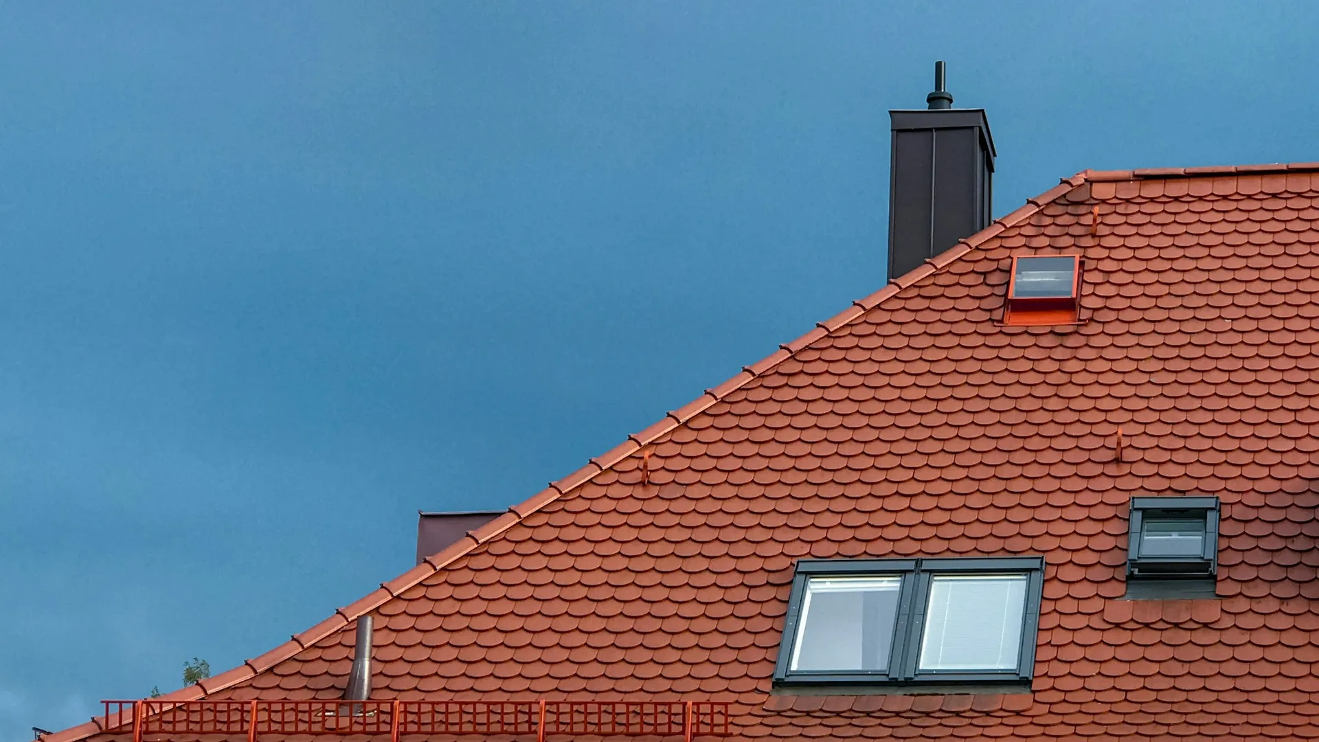 Red tiled roof, roof windows and chimney, roofing contractor in Billingshurst