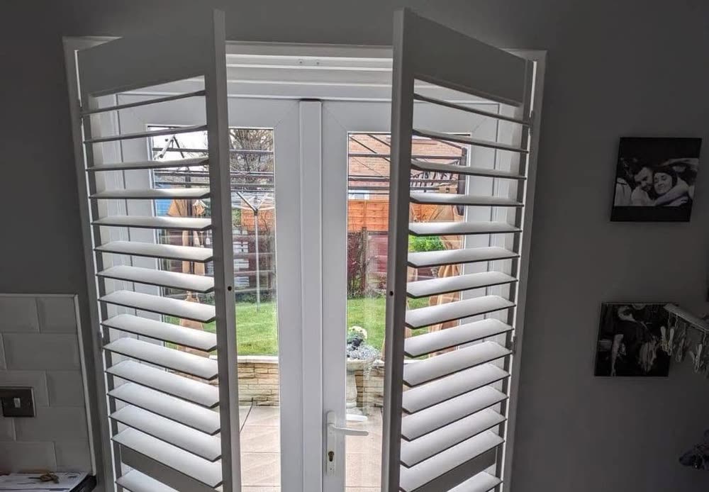 Shutters on French doors, open to the garden