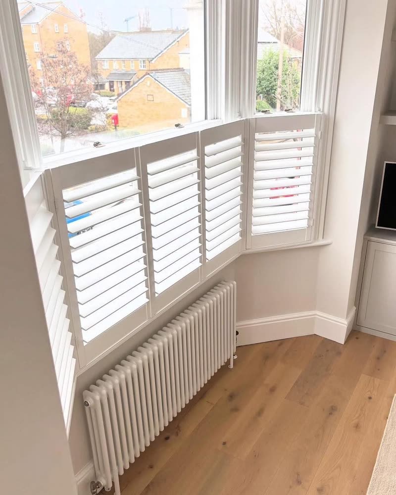 Café style shutters on a period bay with radiator below