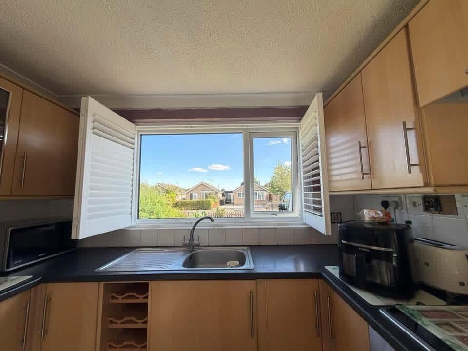 Shutters folded open on a kitchen window