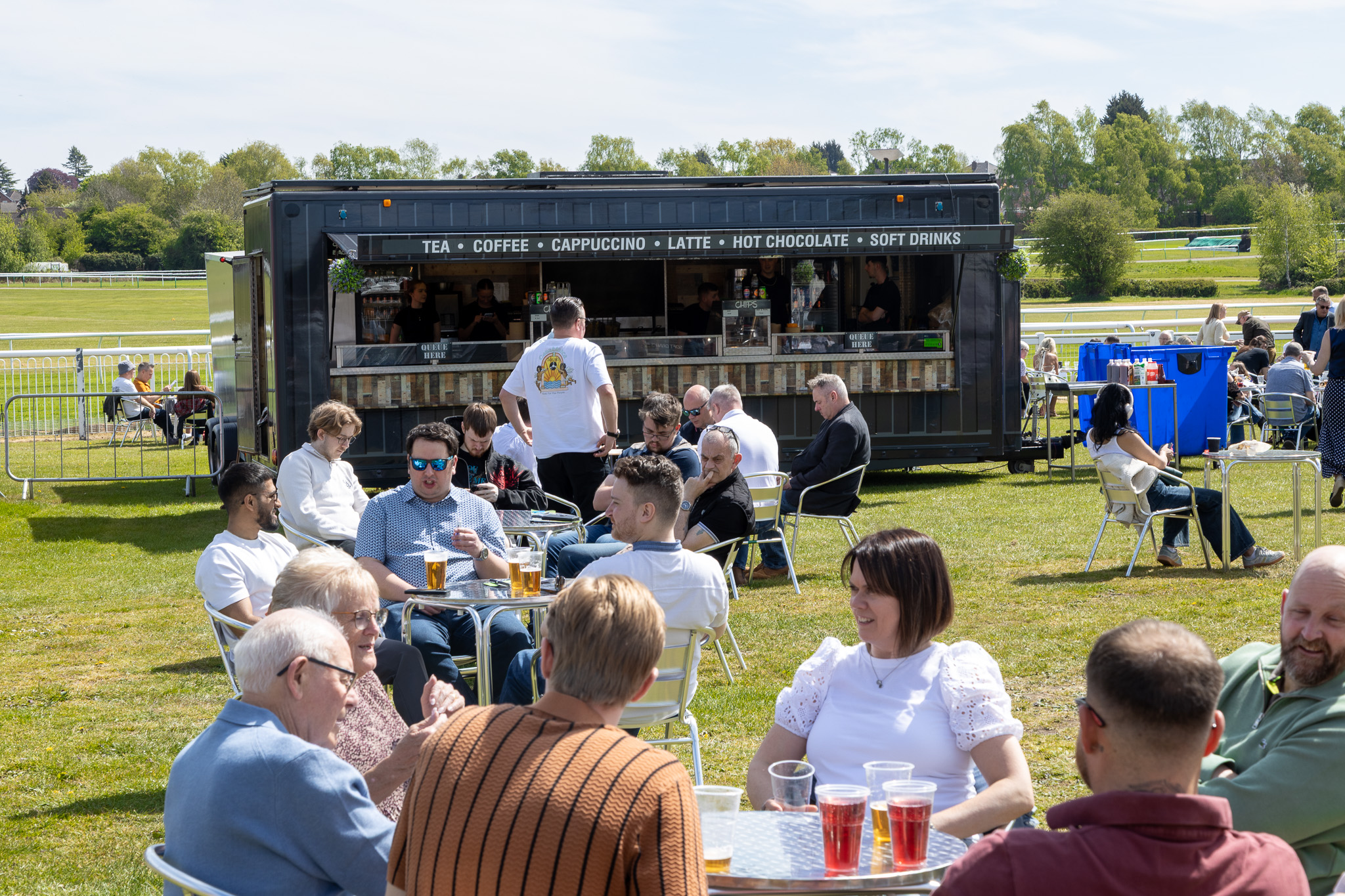 A modern Gourmet Street Kitchen catering trailerefficiently serving freshly prepared meals a capacity event.