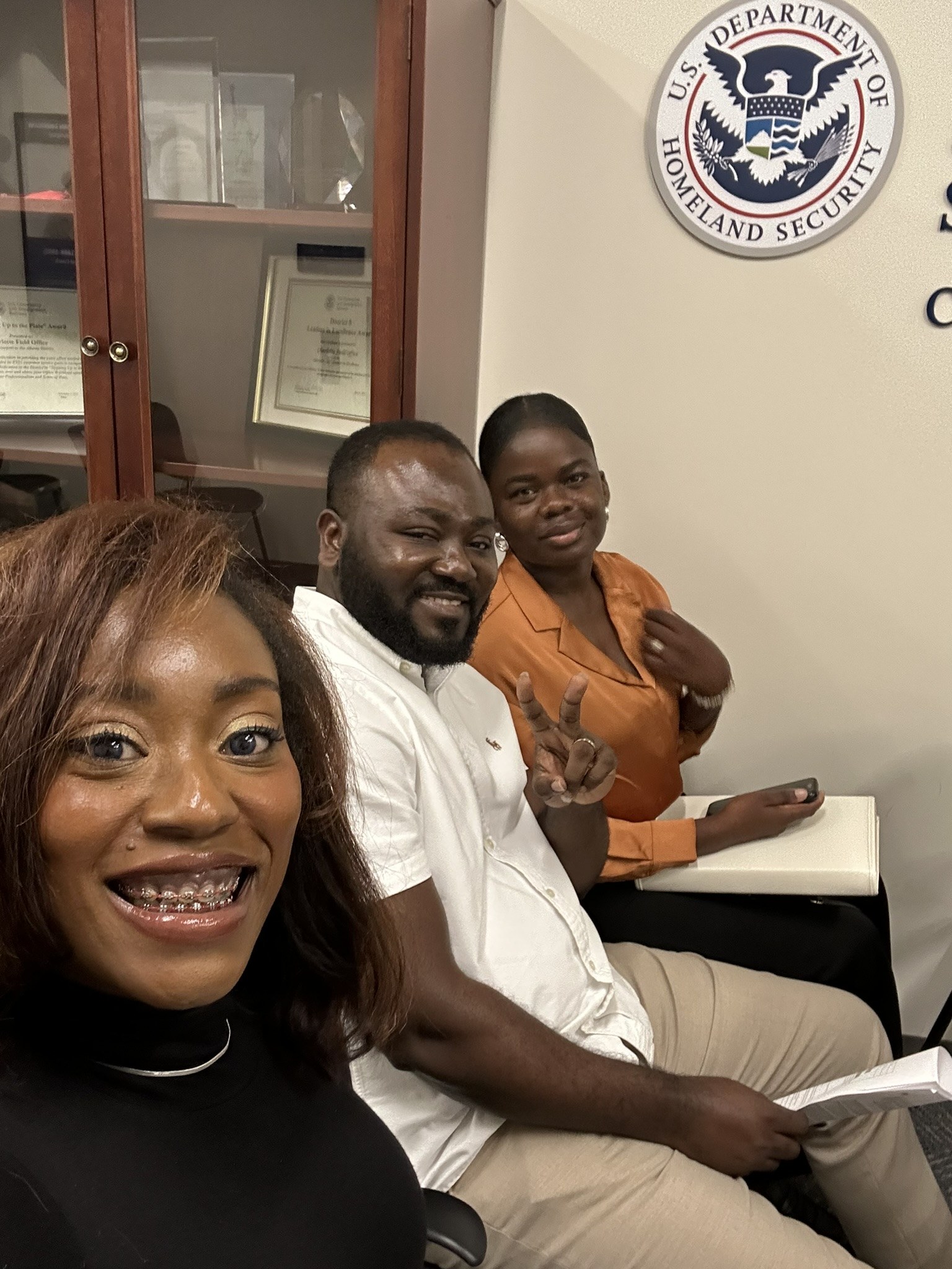Attorney Ify with clients in the USCIS waiting room