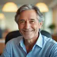 Headshot of a friendly older man smiling in a warmly lit library room for Randy L. testimonial