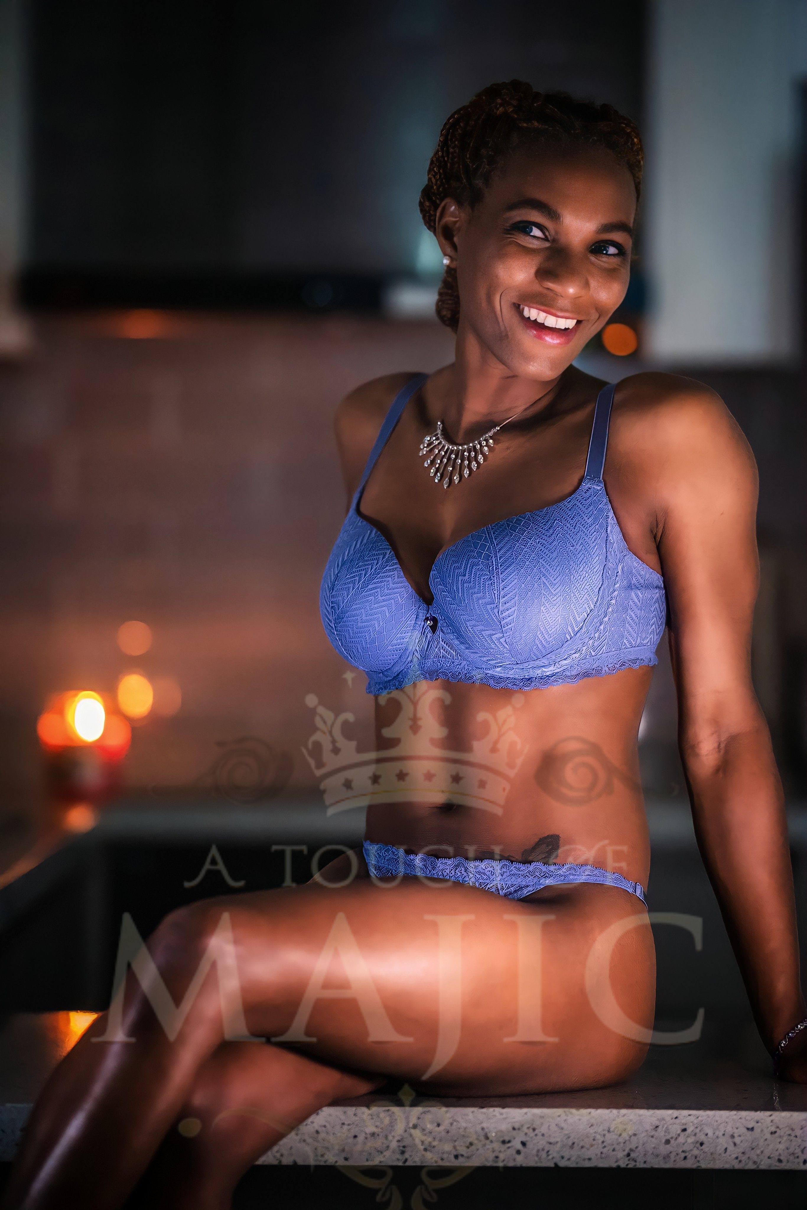 Joyful boudoir portrait of Black woman laughing in sexy blue two piece set