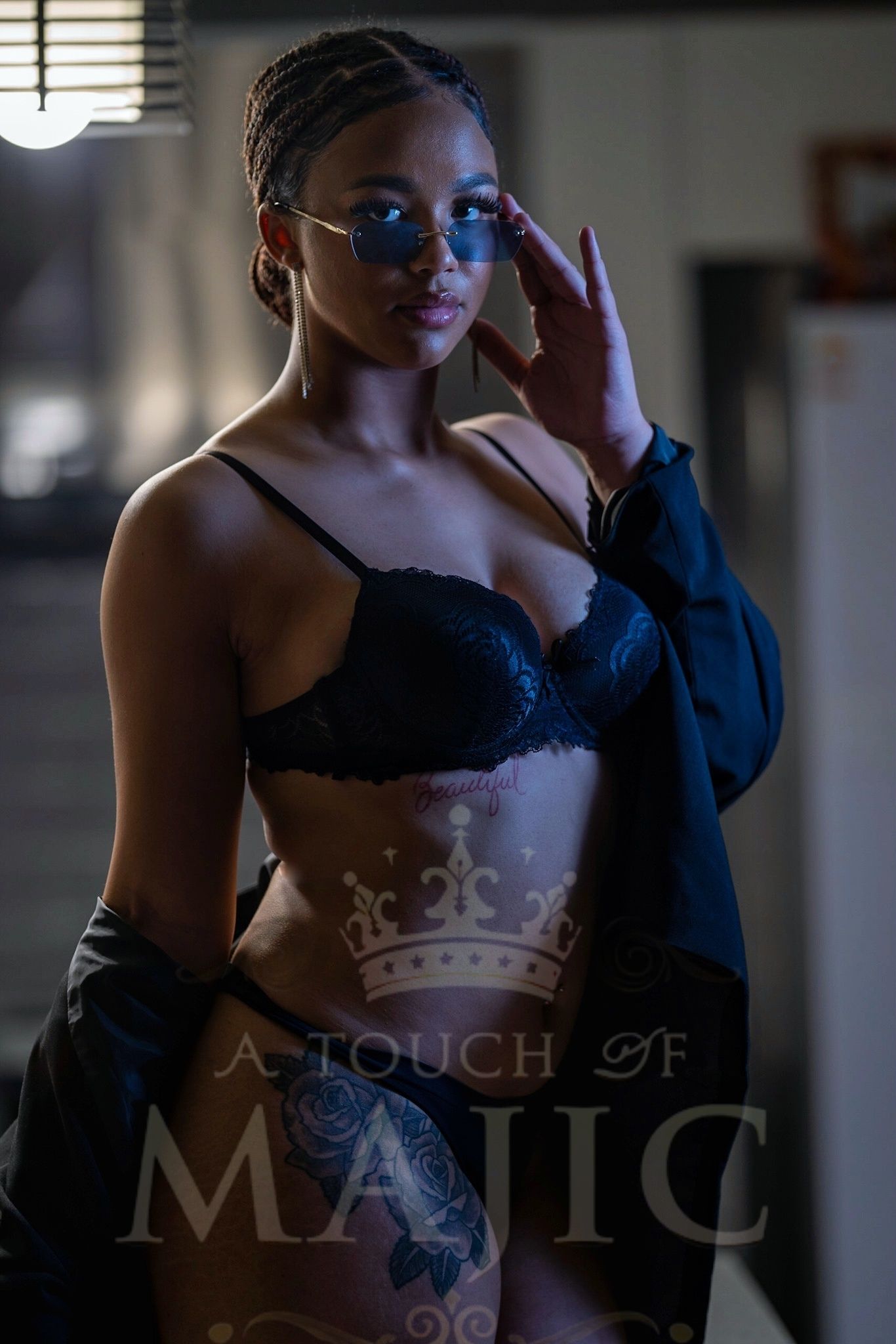 Powerful boudoir portrait of sexy ethnic woman in black under garments with black sunglasses Boudior pose