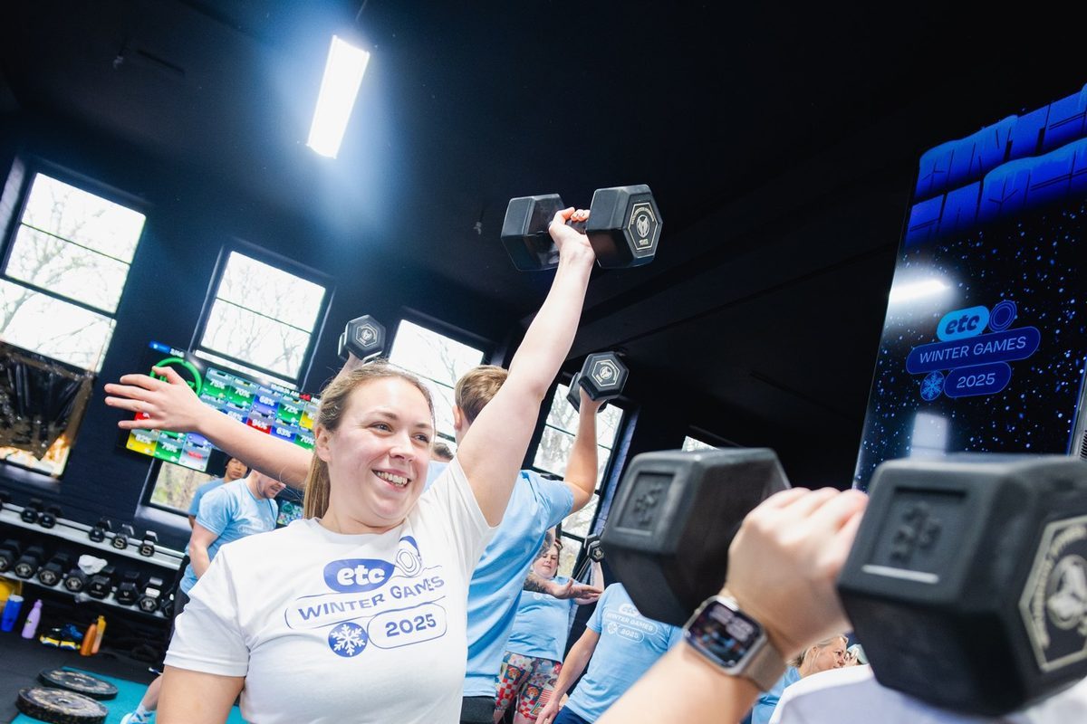 Member mid dumbbell press at the Winter Games