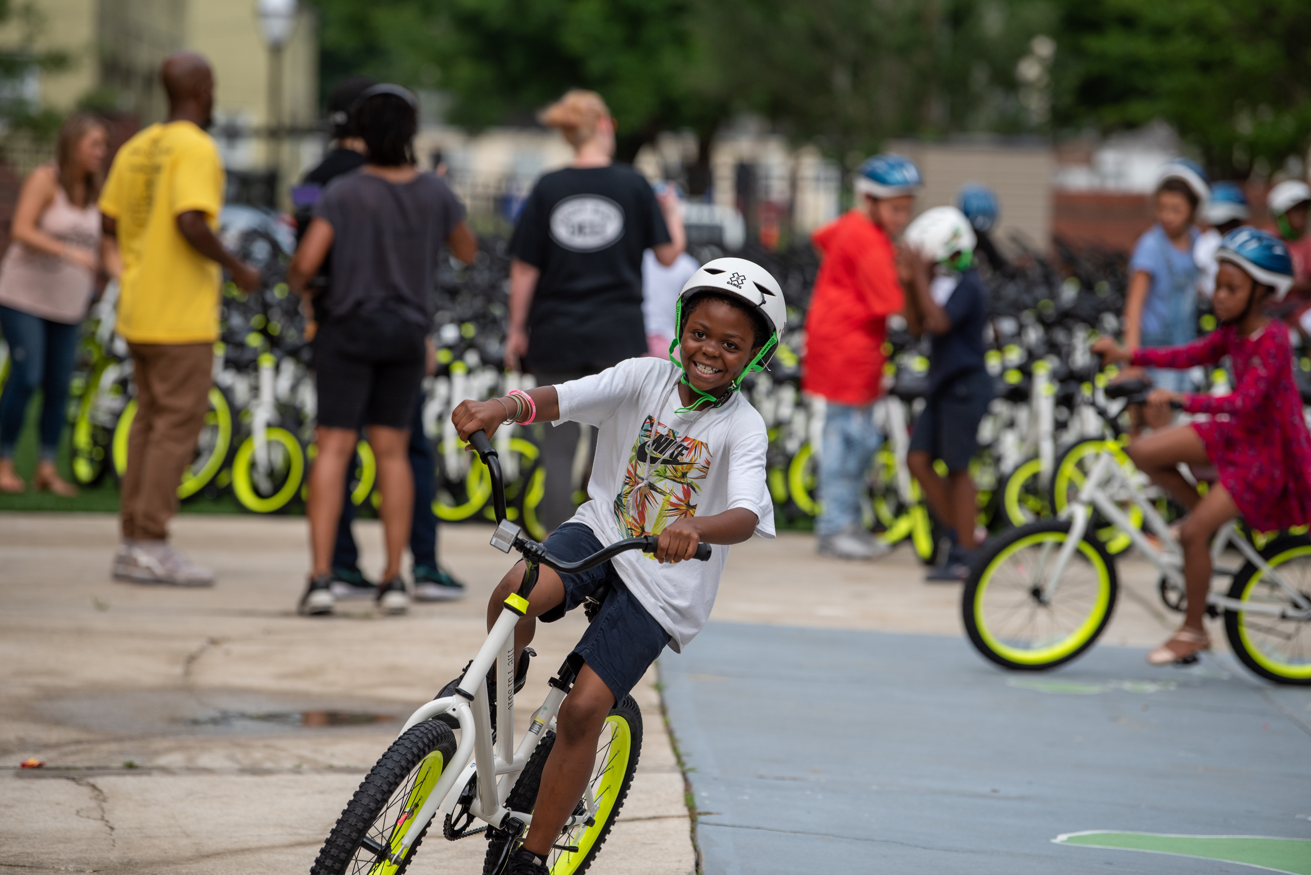 Child smiling on a new bike at a Going Places bike reveal