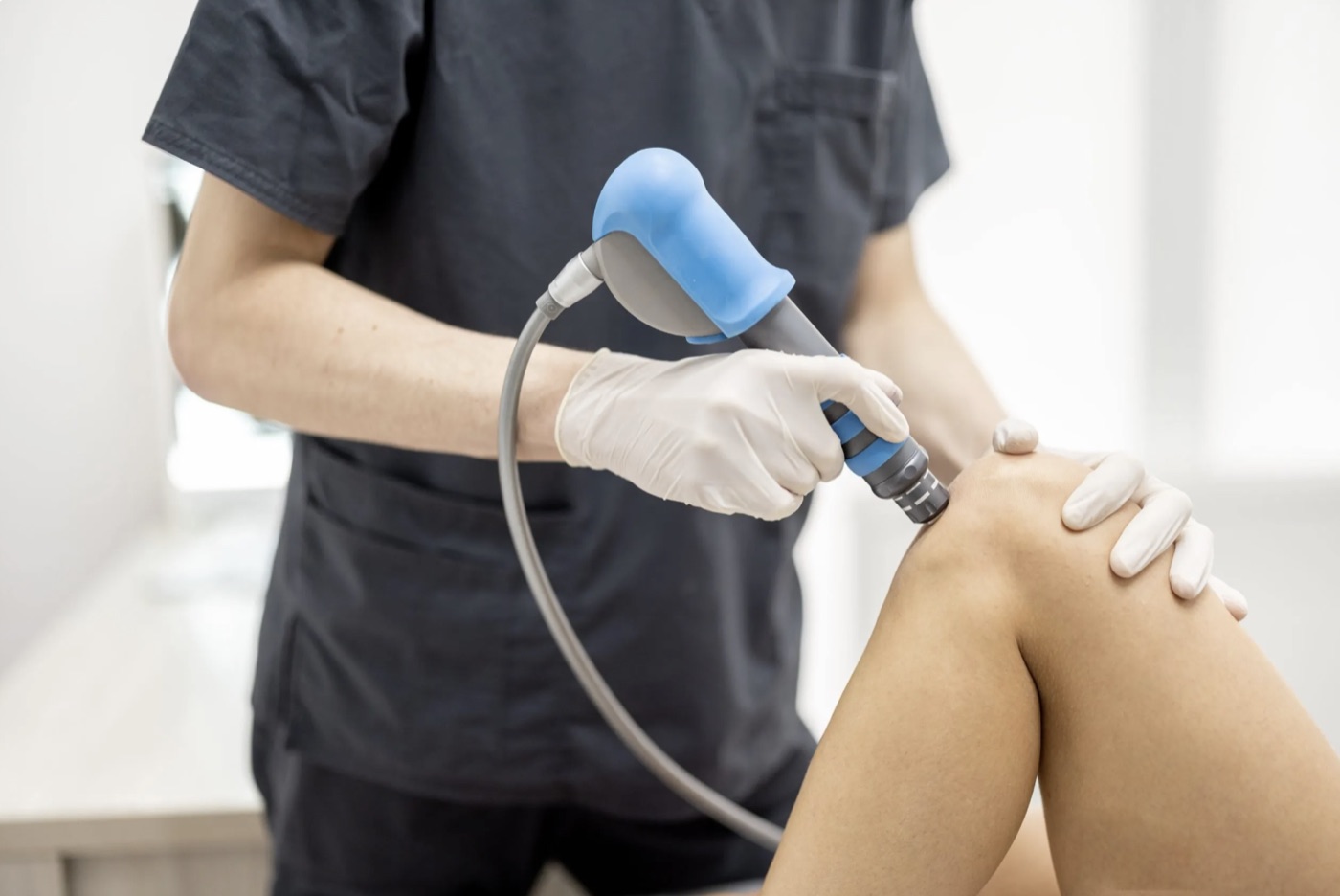 Shockwave therapy on a patient's knee