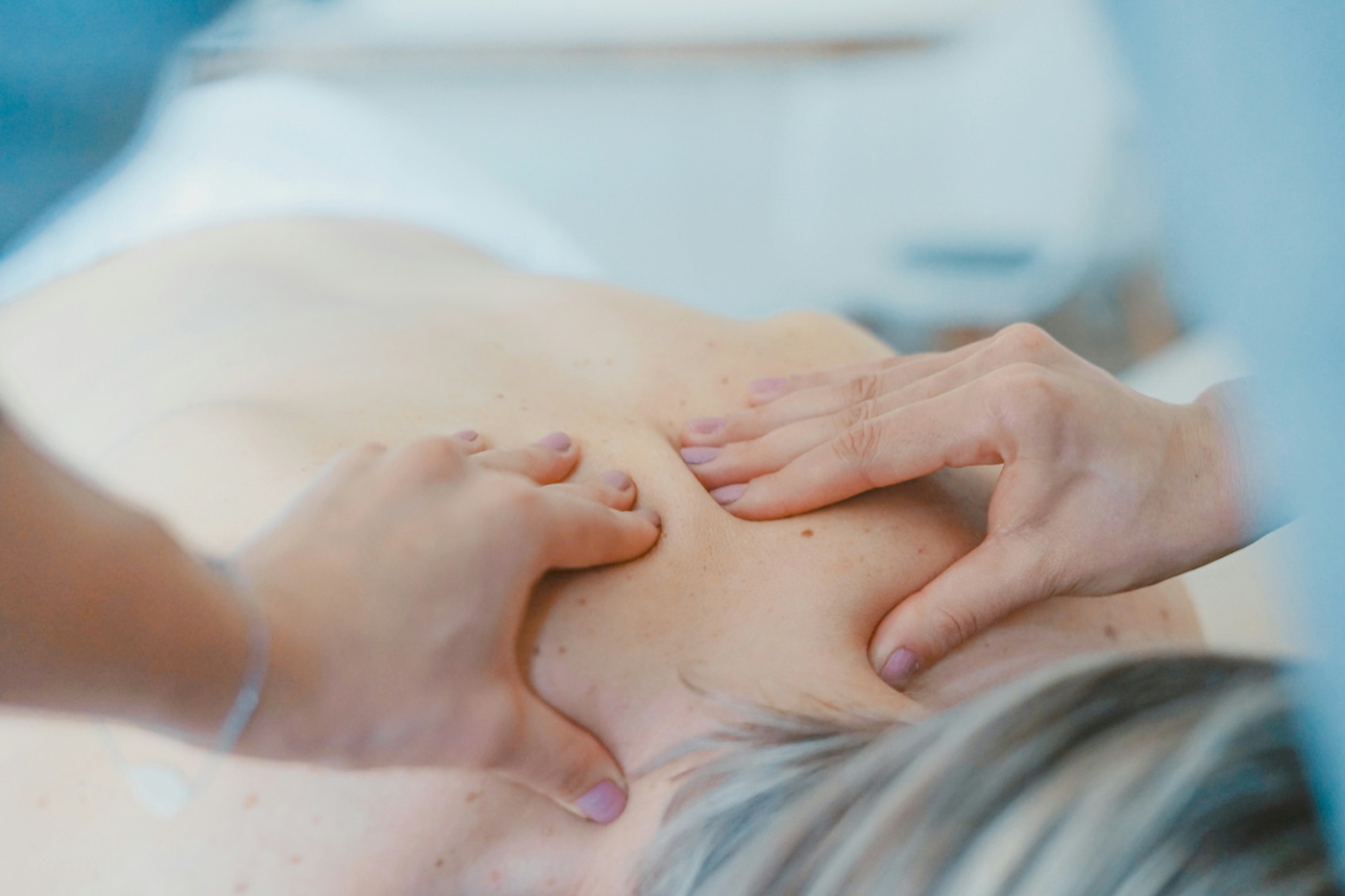 Registered massage therapist working on a patient's back