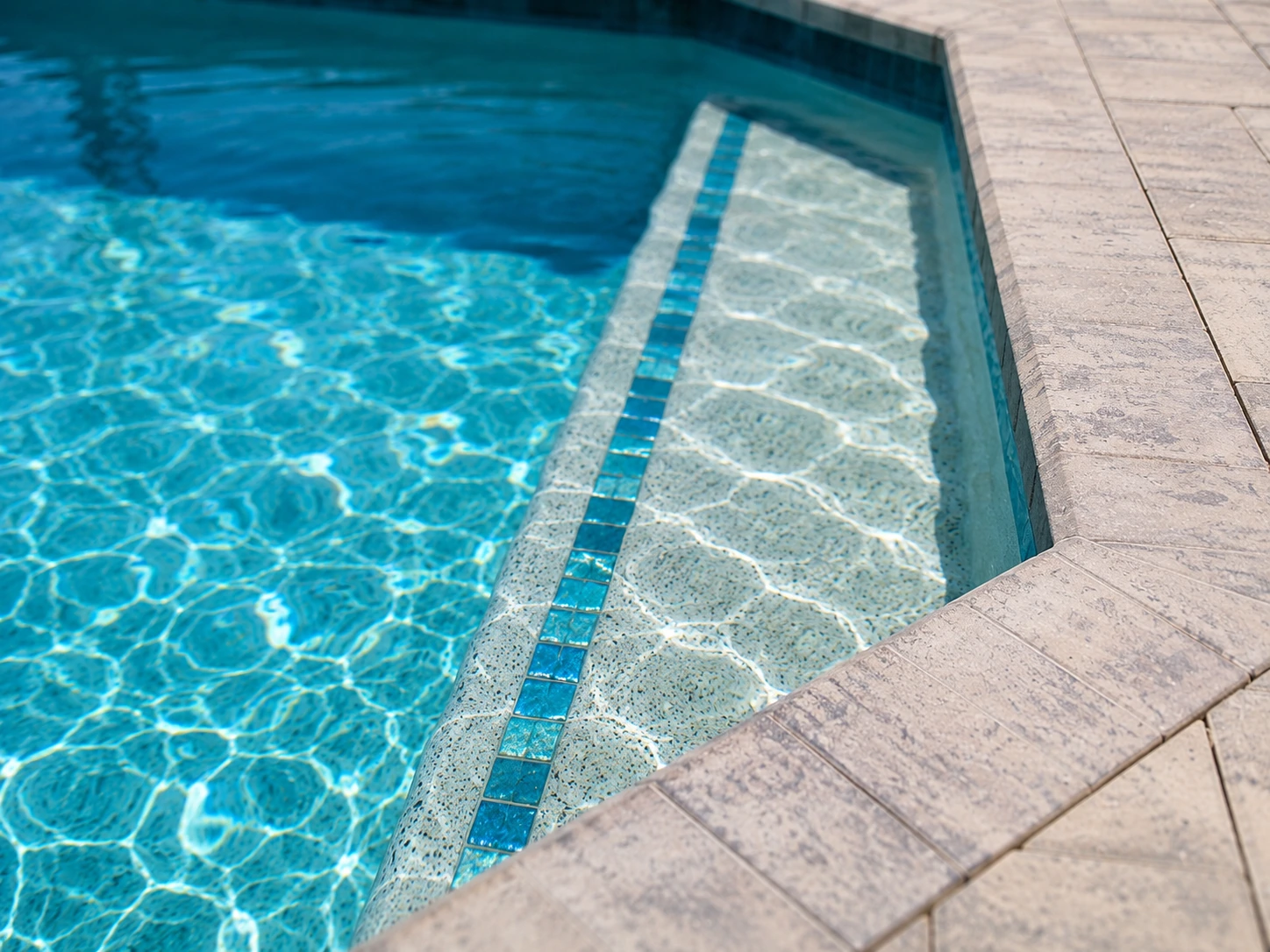 Custom step tile work, coping edges, and built-in bar feature showcasing Design Concepts craftsmanship