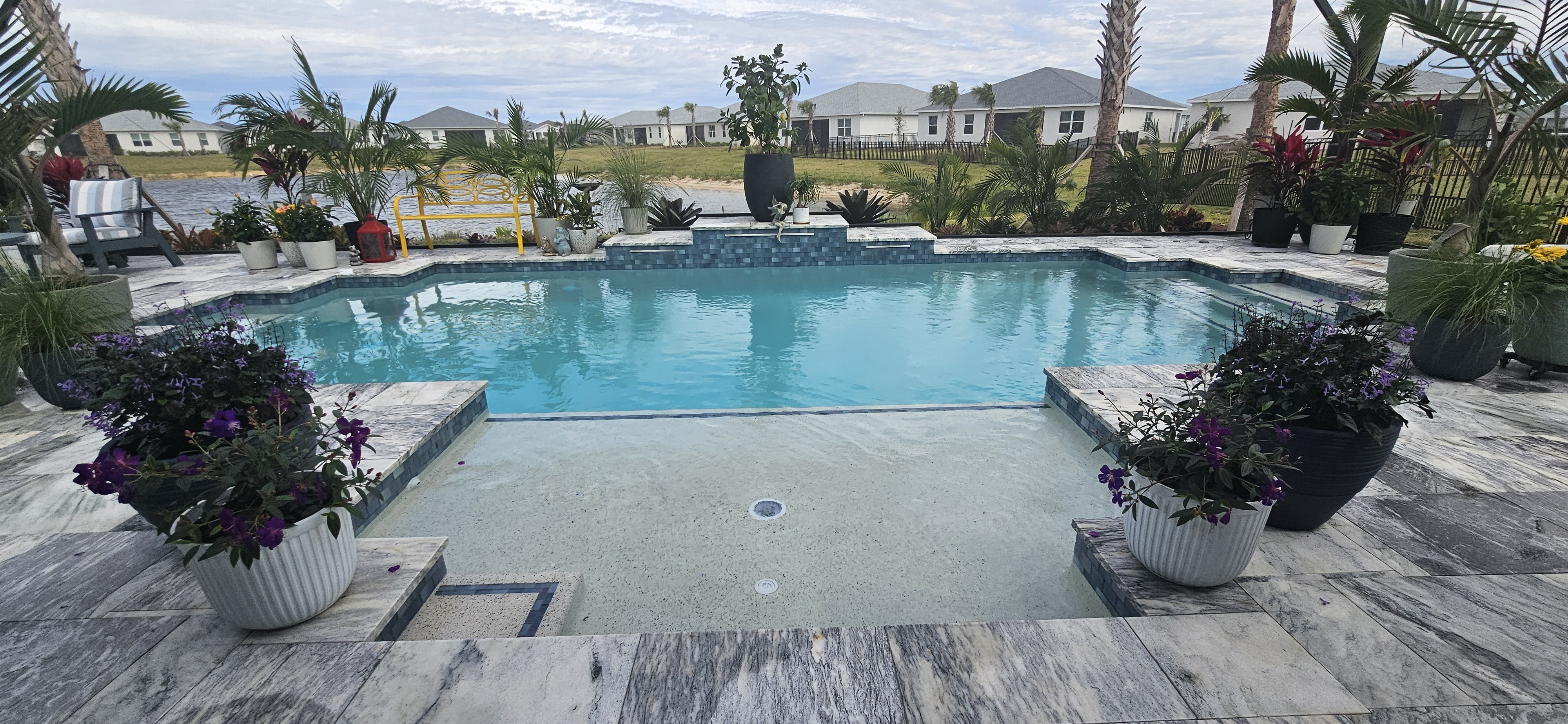 Custom pool with raised spillover spa by Design Concepts