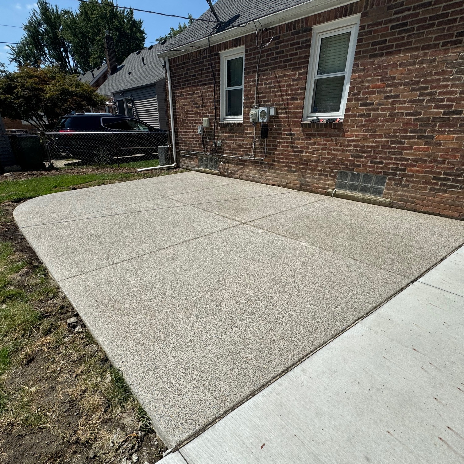 New concrete slab next to a brick home