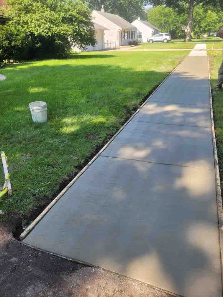 New concrete sidewalk through a residential yard