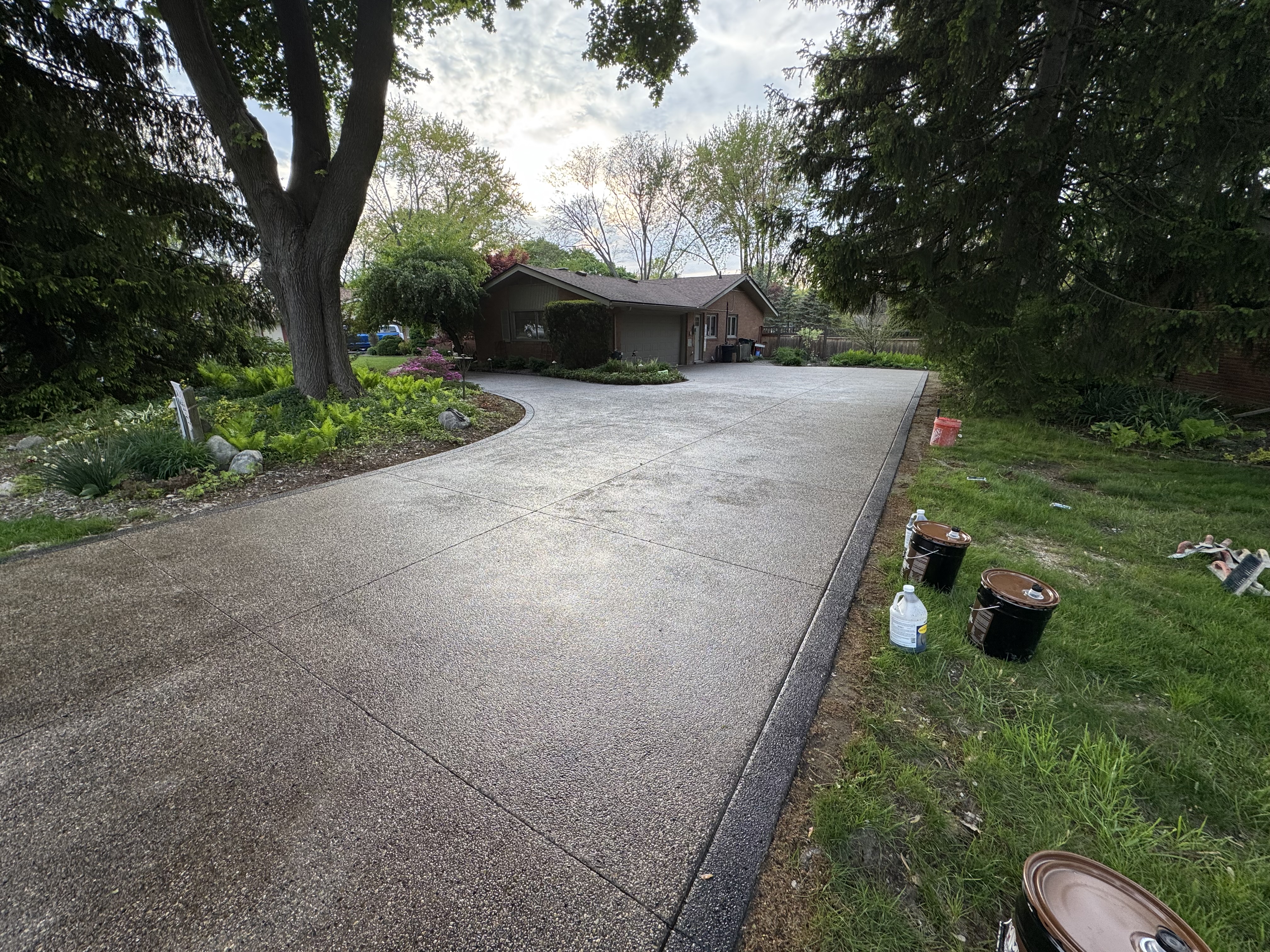 Long curved concrete driveway on a wooded lot
