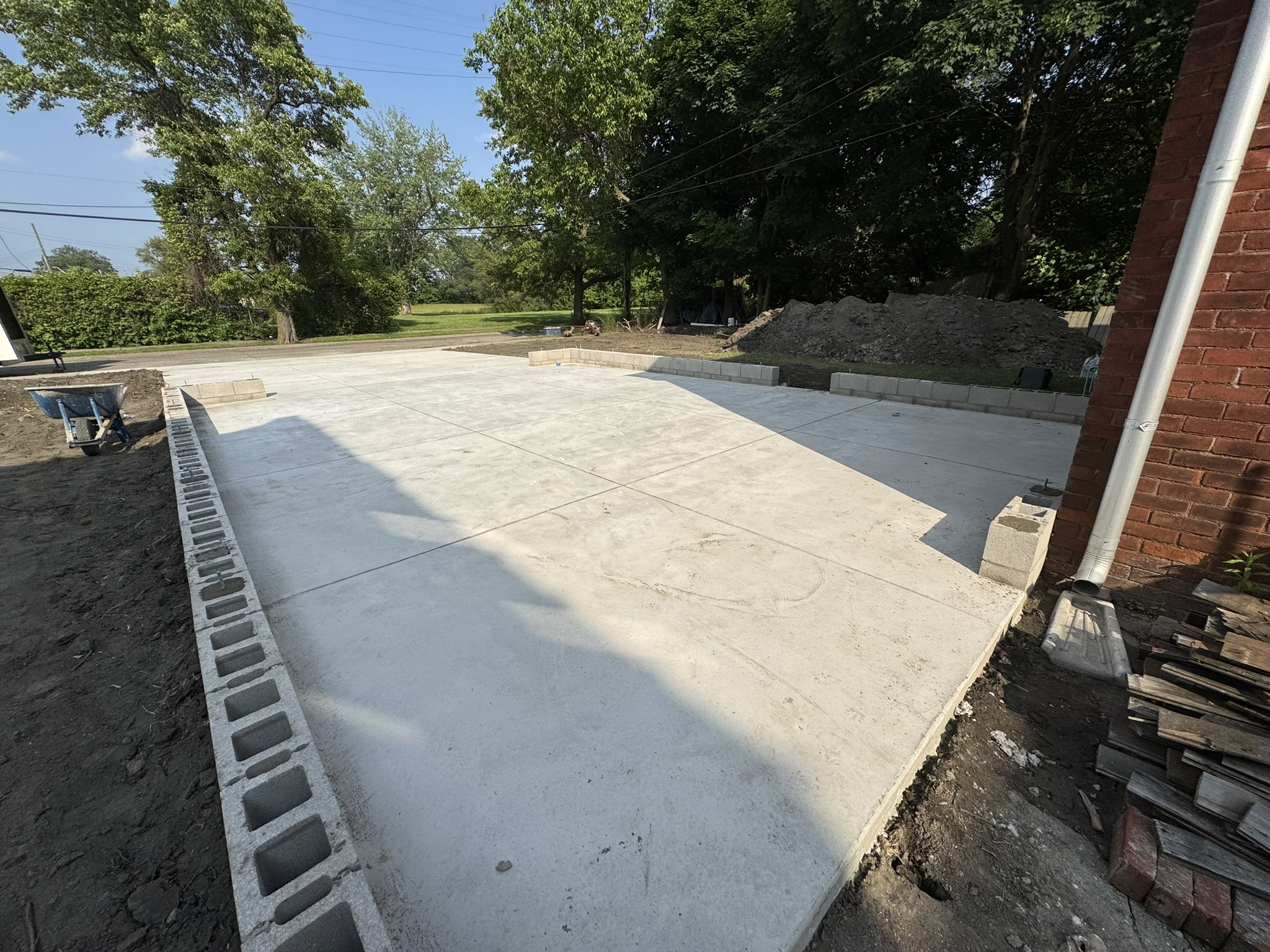 Formed and finished concrete slab beside a home