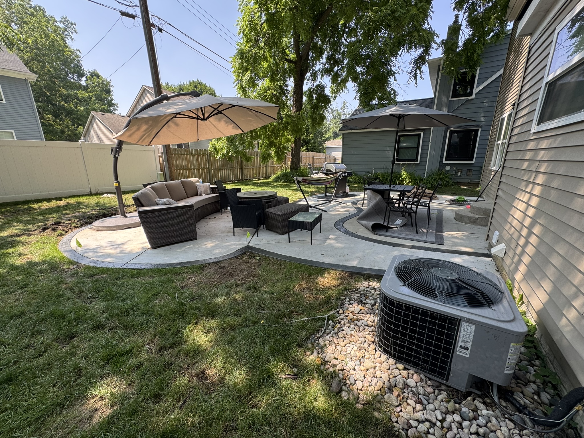 Backyard concrete patio with seating area in Metro Detroit