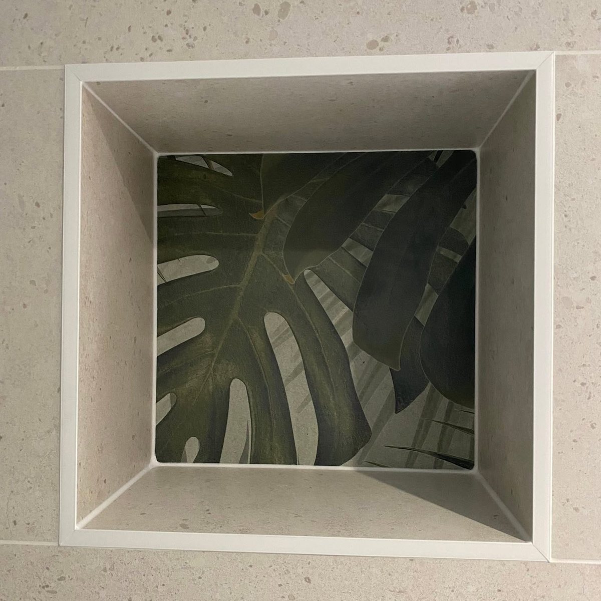 Tiled shower niche with palm leaf feature tile inset