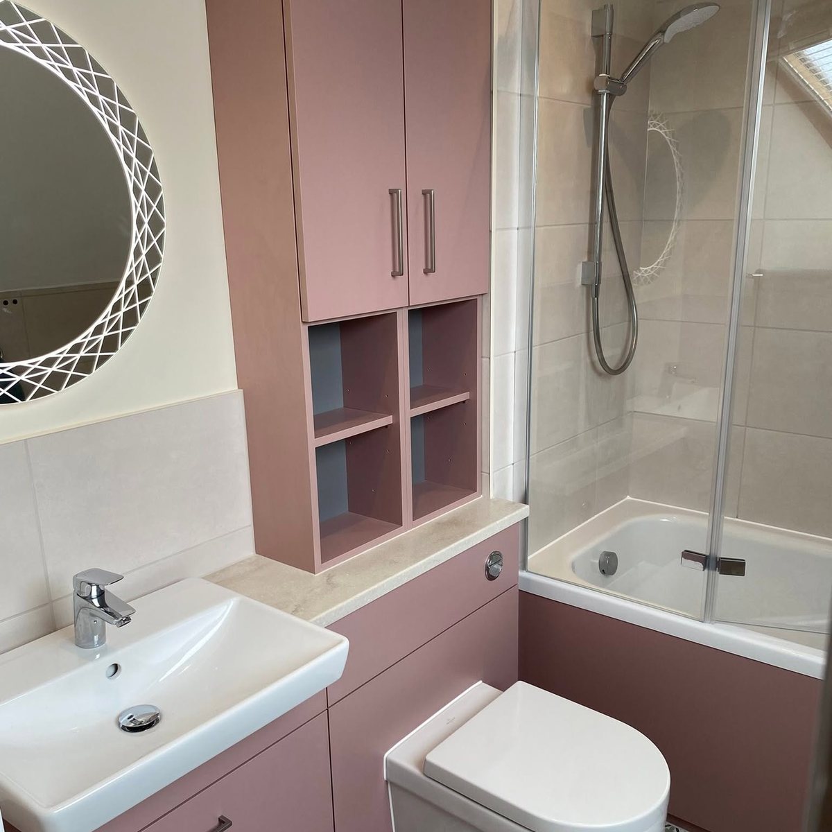 Bathroom with dusky pink fitted storage and shower bath