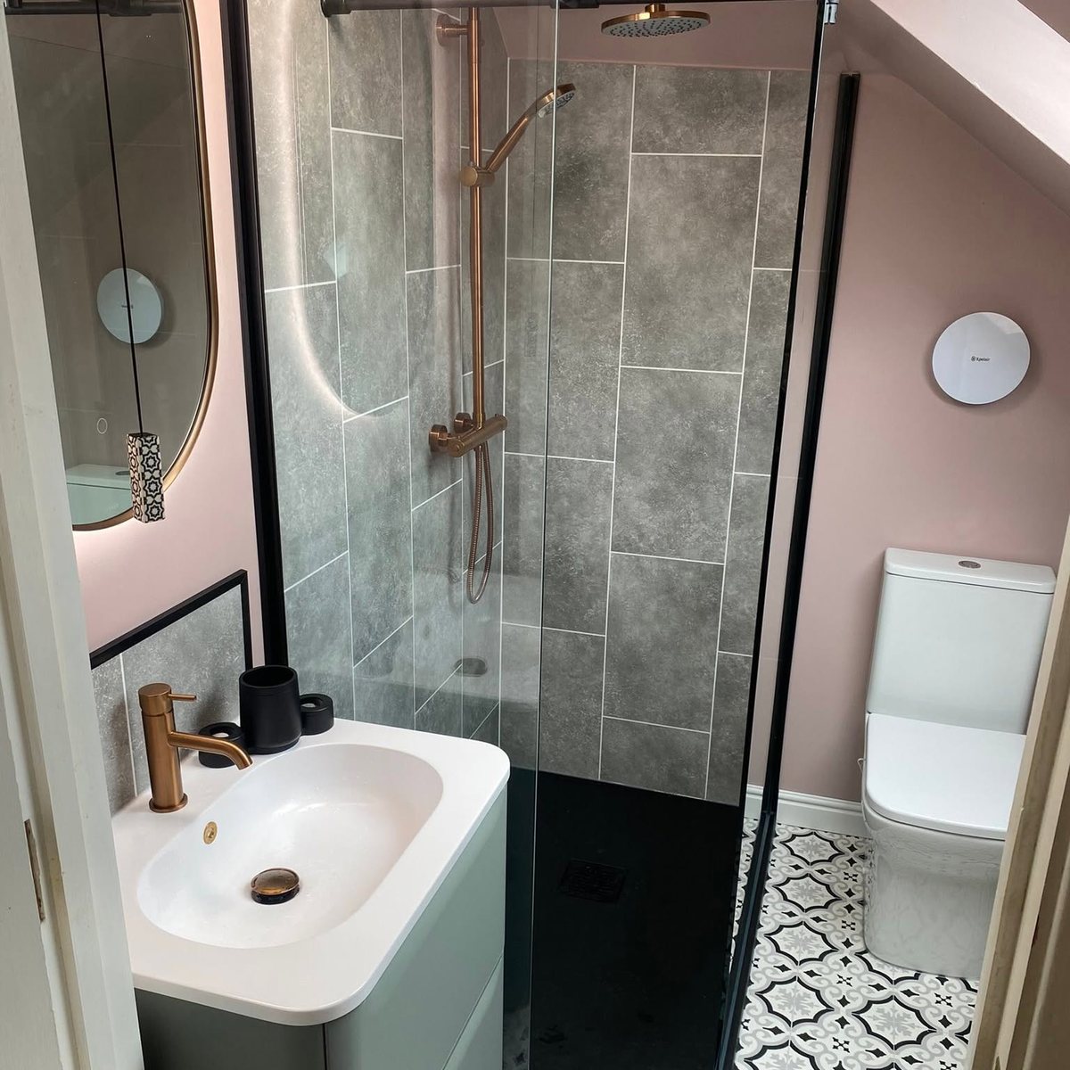 Loft en-suite with walk-in shower, pink walls and copper fittings