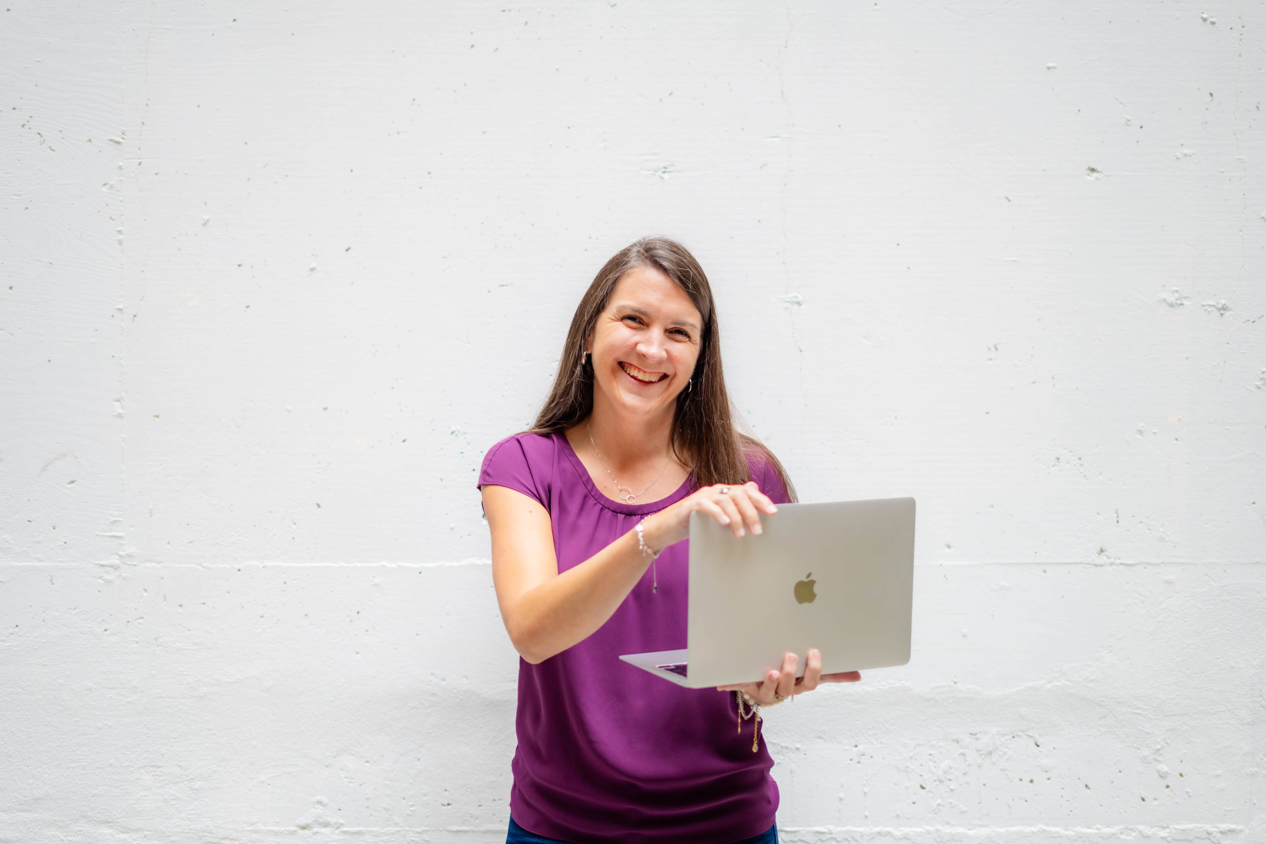 Mary Louise Rose women's wellness coach at Health Your Way smiling and holding a laptop ready to help women build sustainable health through personalized nutrition fitness and mindset coaching