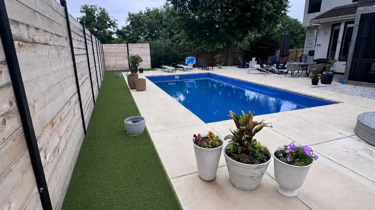 Completed poolside artificial turf project with clean finished edges in Kansas City