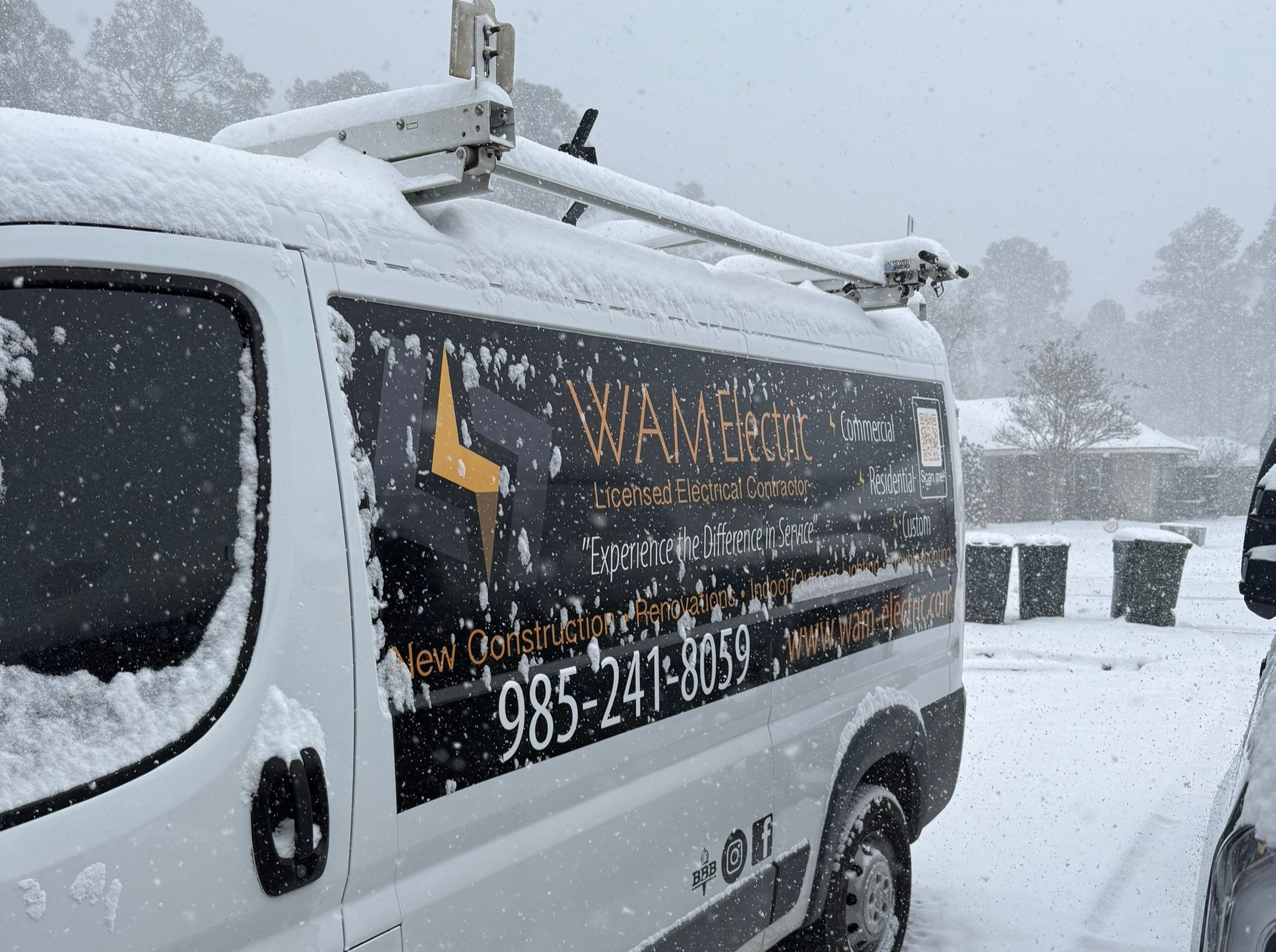 WAM Electric service van during a rare Louisiana snowstorm, ready for emergency calls.
