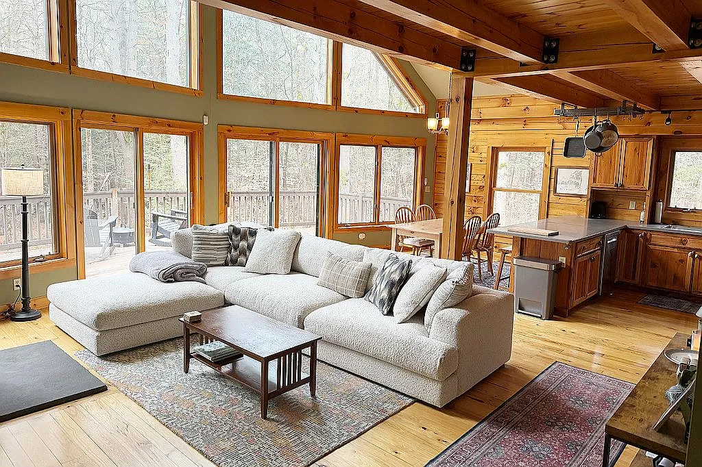 Log home exterior with wraparound deck and wall of windows
