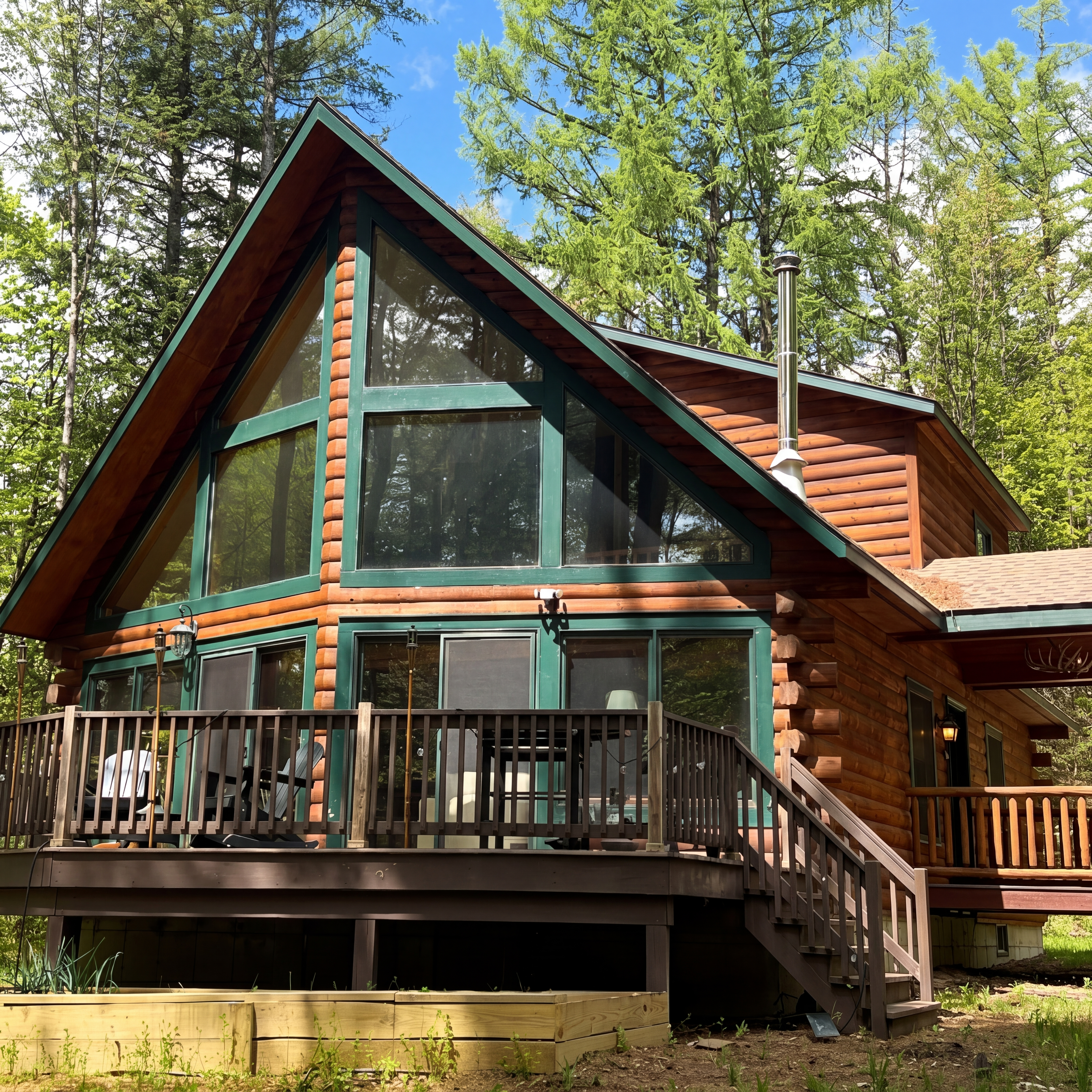 Authentic log home at 112 Ballou Rd surrounded by autumn forest