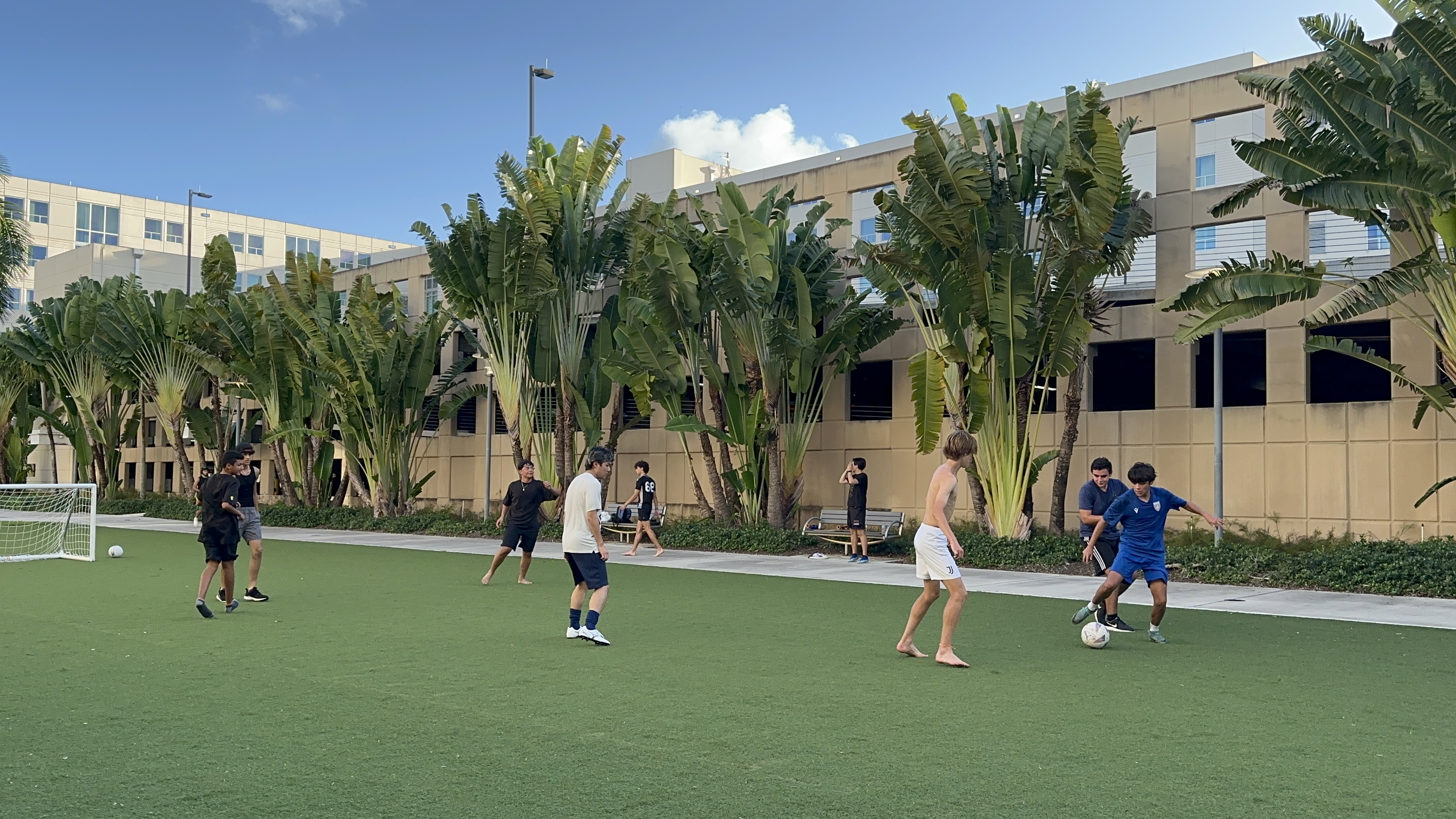 BIZNOVATOR Camp campers playing soccer on campus