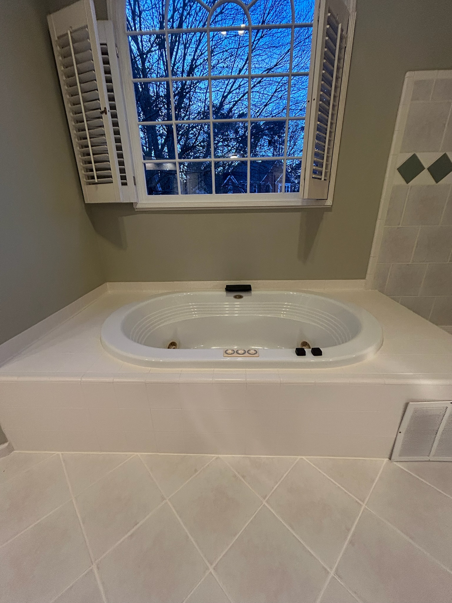 Bathroom floor after grout restoration near jacuzzi tub in Woodstock GA