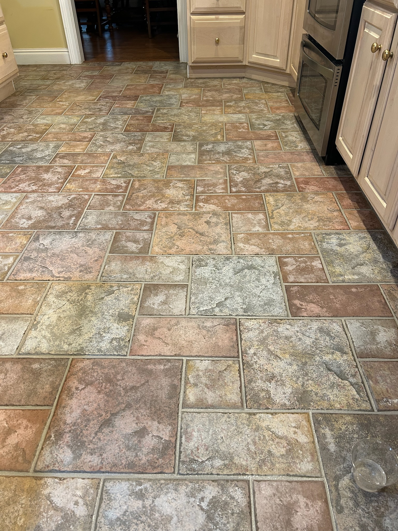 Same kitchen floor with restored bright grout after service
