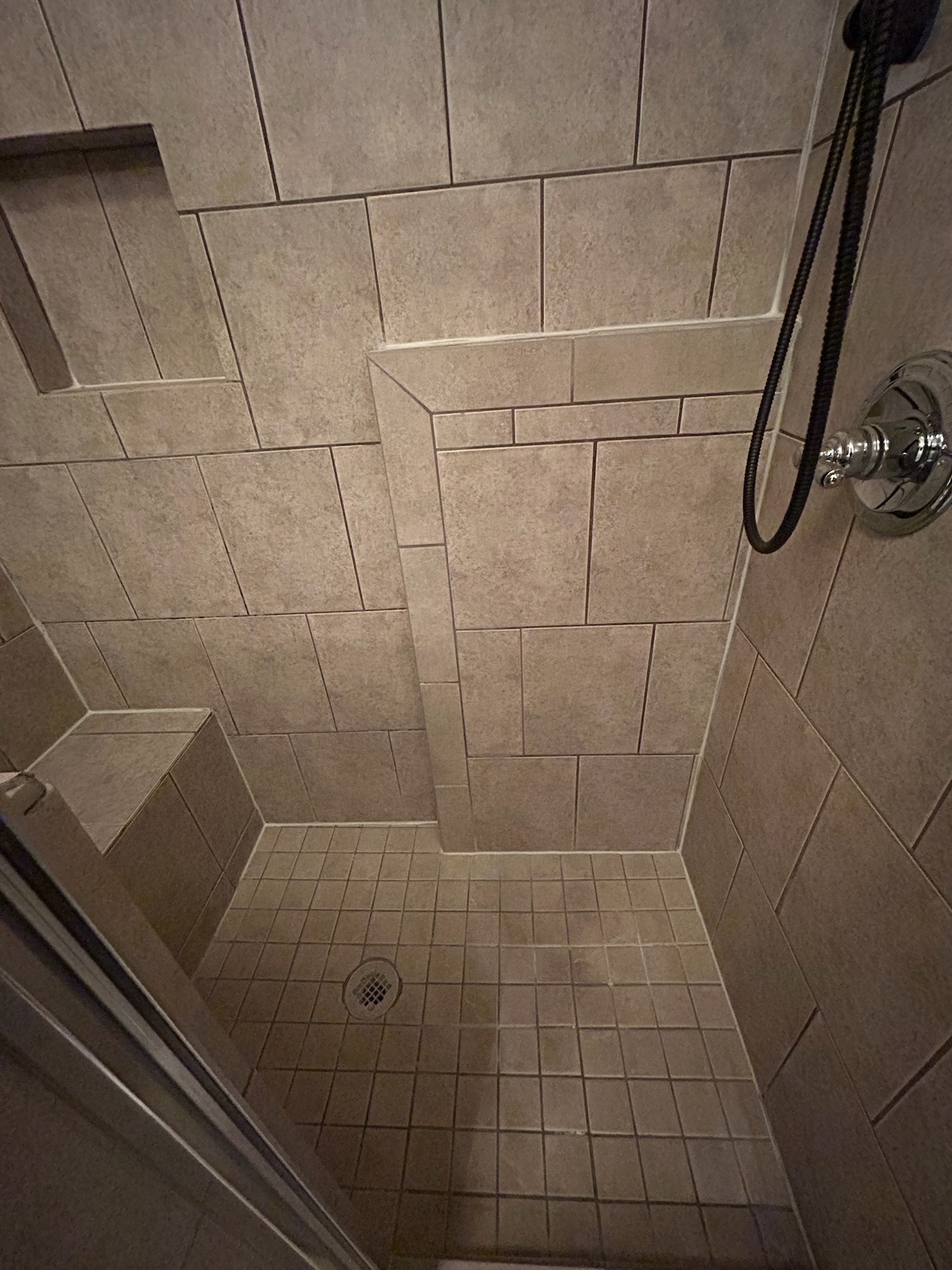 Shower with worn grout and discoloration